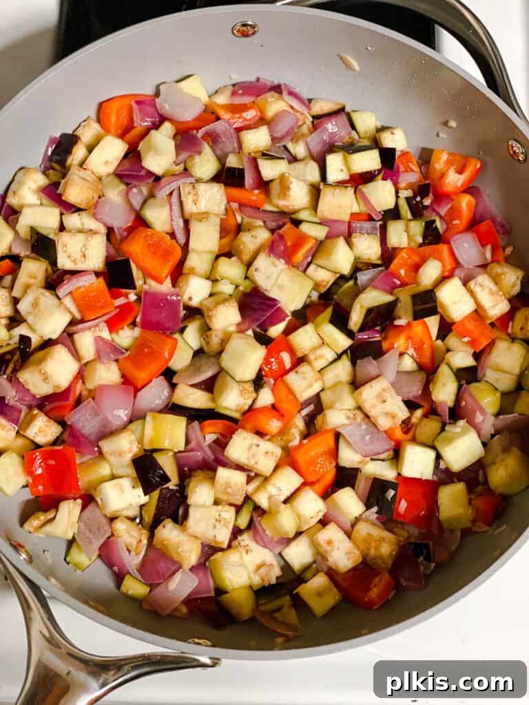 Effortless Eggplant Penne Alla Norma 8 Eggplant and red peppers cooking and softening in the pan.