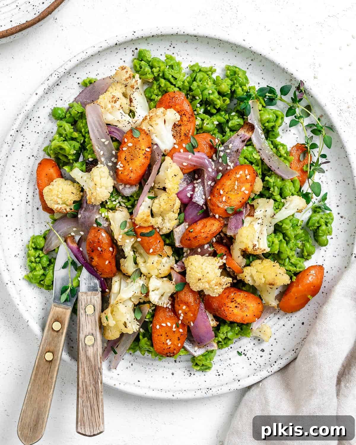 Effortless Creamy Peas with Golden Roasted Vegetables 2 completed Easy Mushy Peas with Roasted Veggies plated on a white bowl against a light background