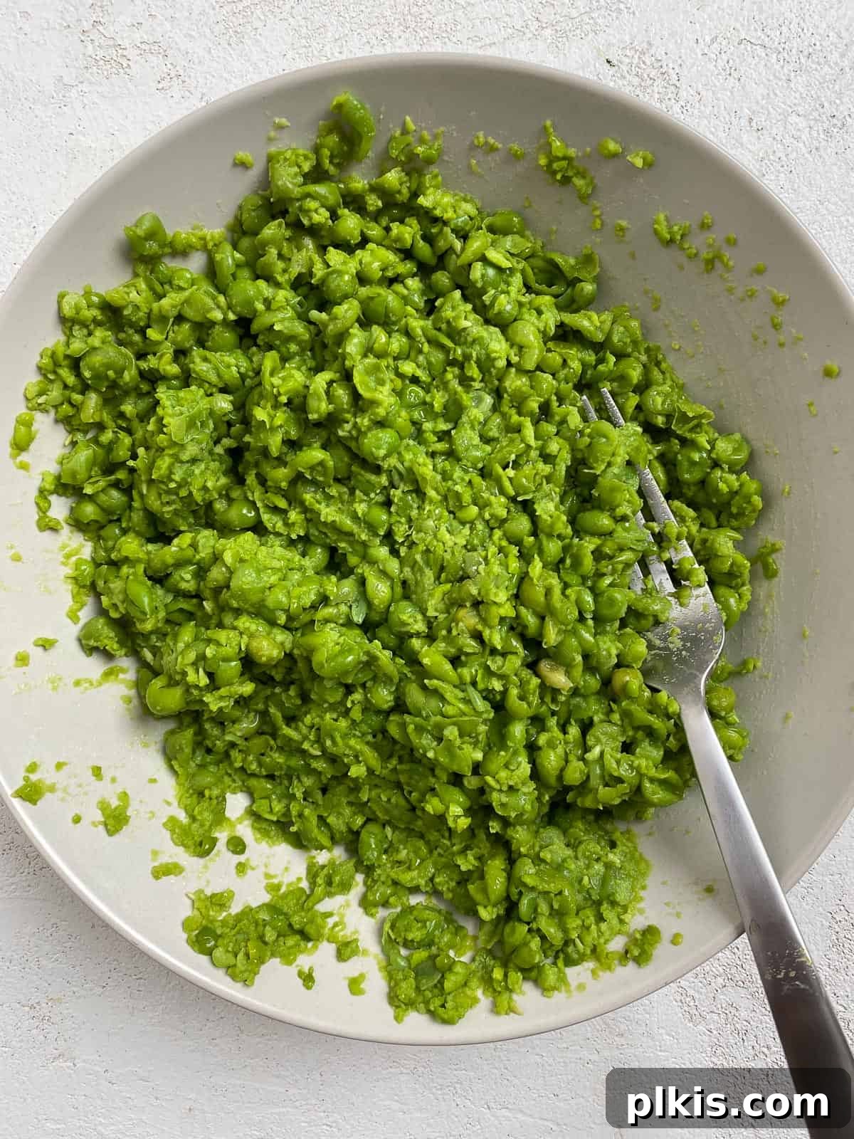 Effortless Creamy Peas with Golden Roasted Vegetables 8 post mashing of peas in a white dish