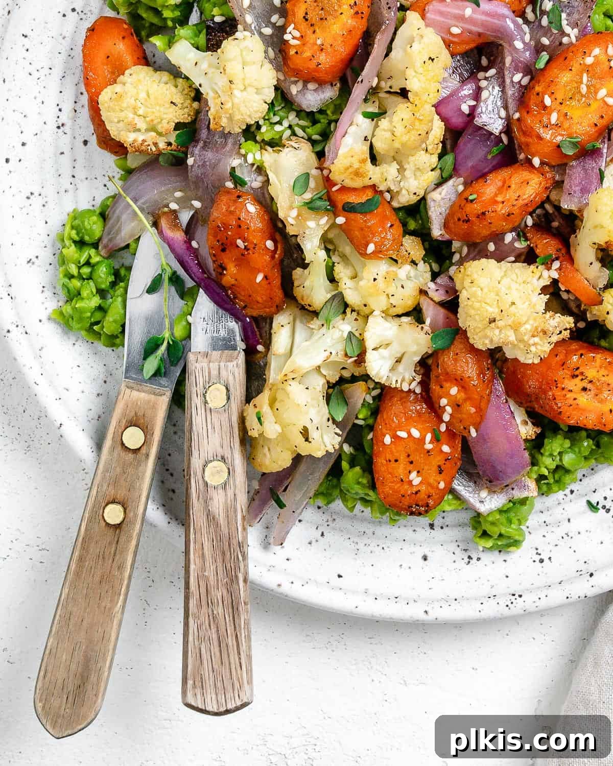 Effortless Creamy Peas with Golden Roasted Vegetables 10 completed Easy Mushy Peas with Roasted Veggies plated on a white bowl against a light background