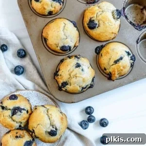 completed blueberry banana muffins in tin and plated against white surface