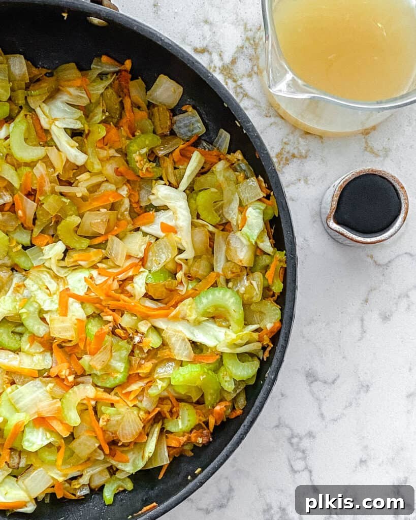Easy Veggie Chow Mein A Delicious Plant-Based Bargain 5 process of veggies being cooked in black pan with sauce ingredients on the side against a white background
