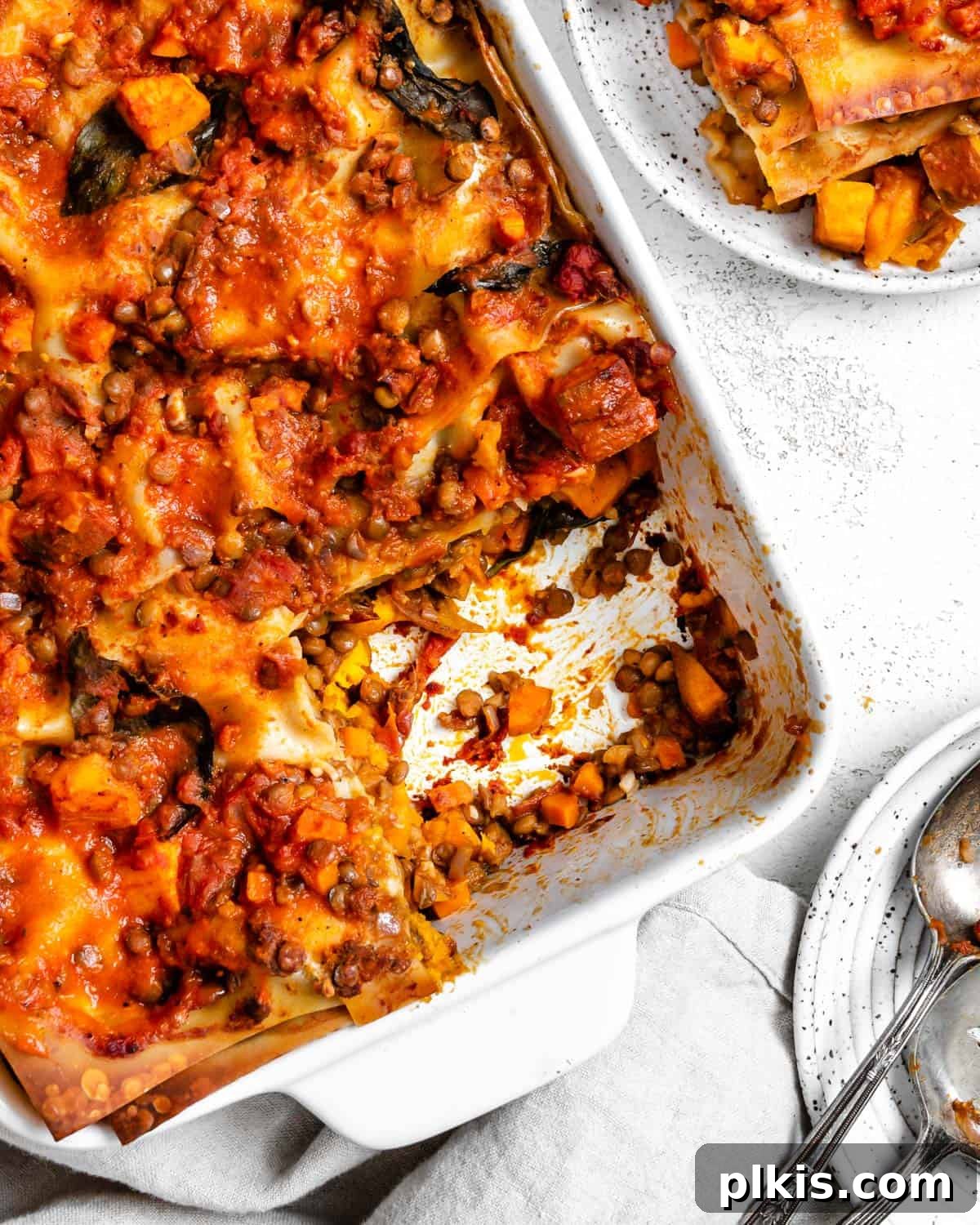 Deliciously Easy Vegan Sweet Potato Lasagna 2 completed Easy Sweet Potato Lasagna in a baking dish against a white surface