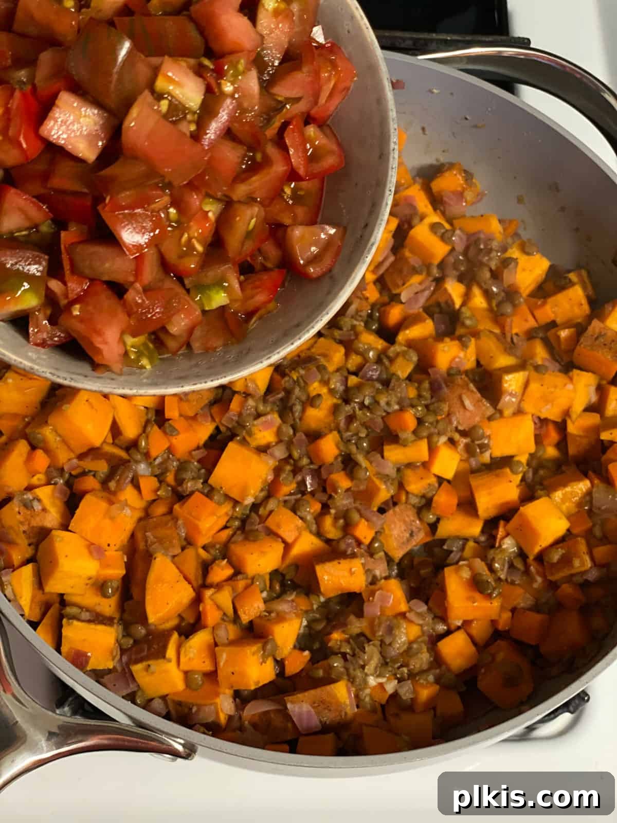 Deliciously Easy Vegan Sweet Potato Lasagna 11 process shot of adding chopped tomatoes to pan