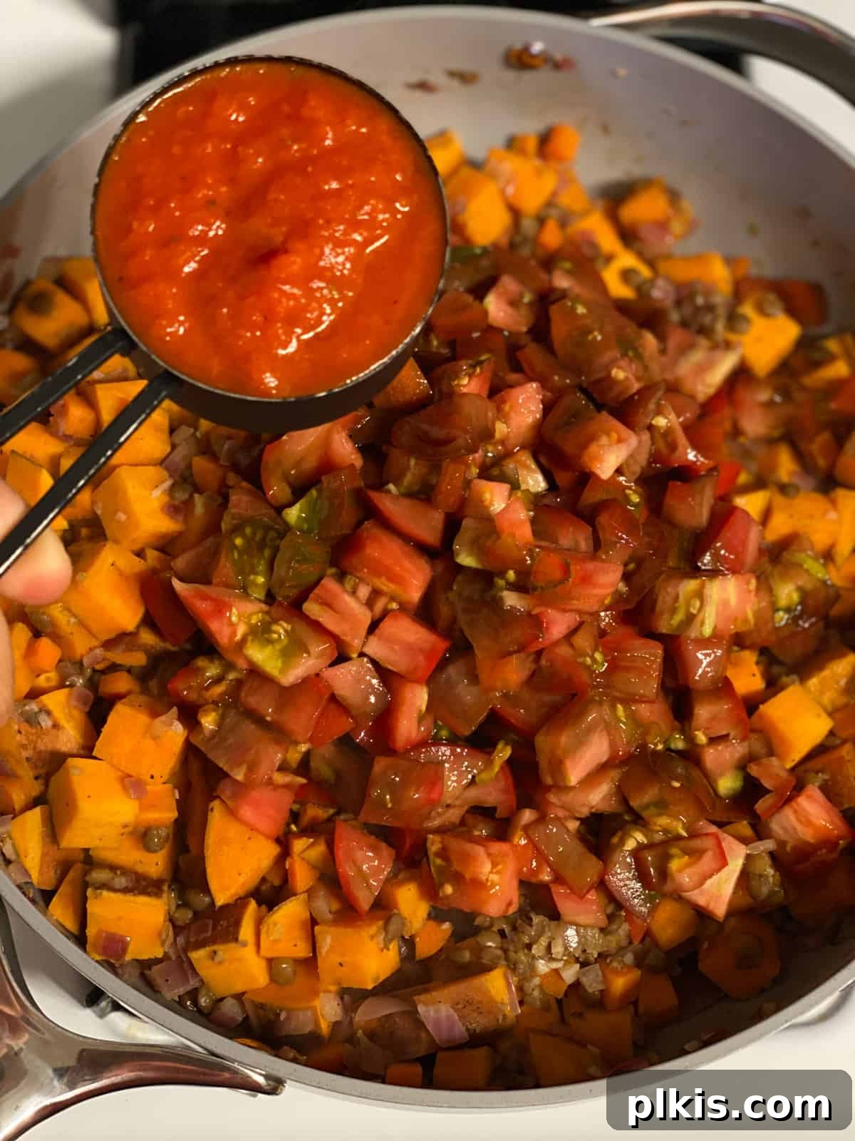 Deliciously Easy Vegan Sweet Potato Lasagna 12 process shot of adding passata to pan