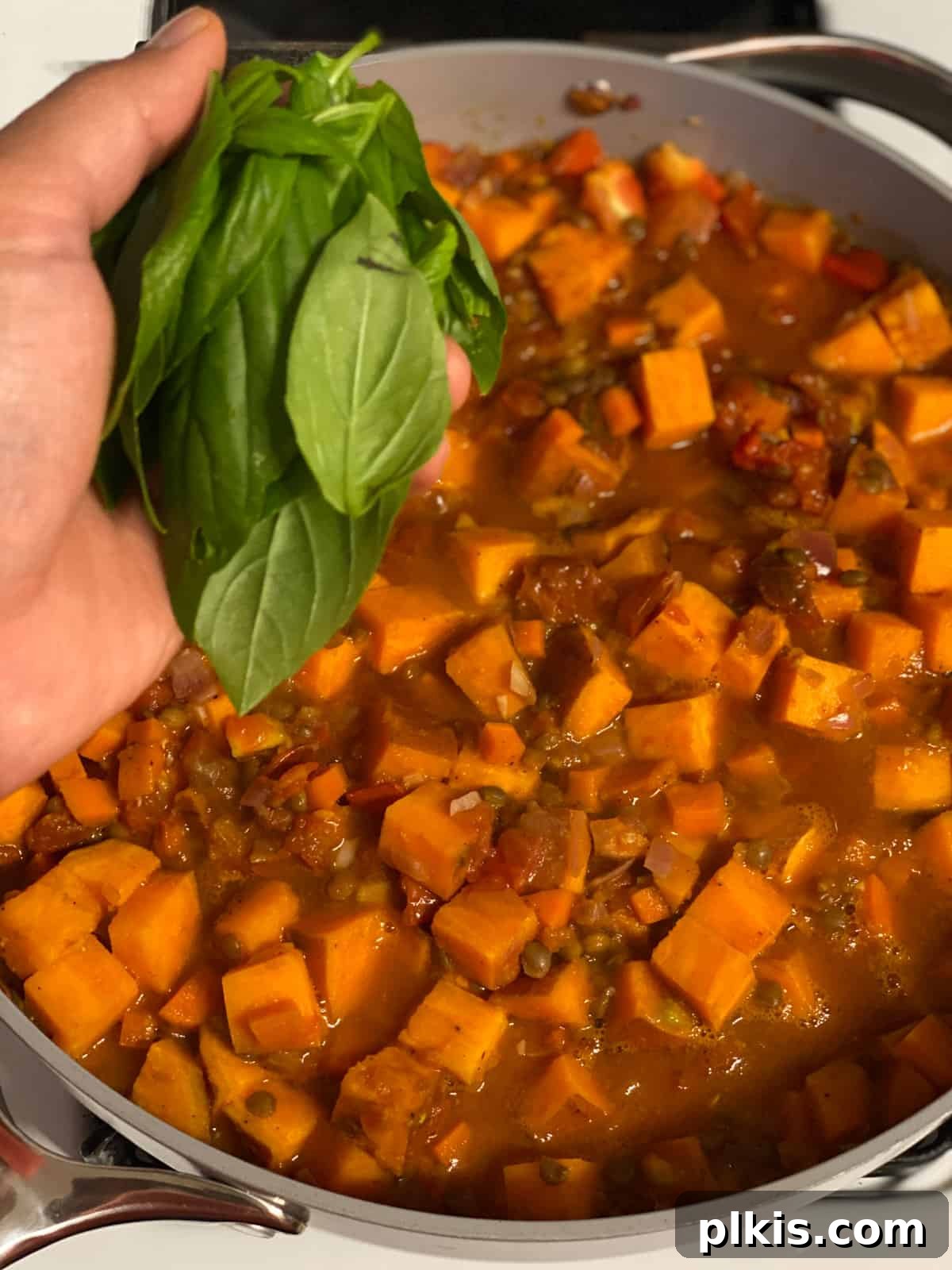 Deliciously Easy Vegan Sweet Potato Lasagna 14 process shot of adding basil to pan