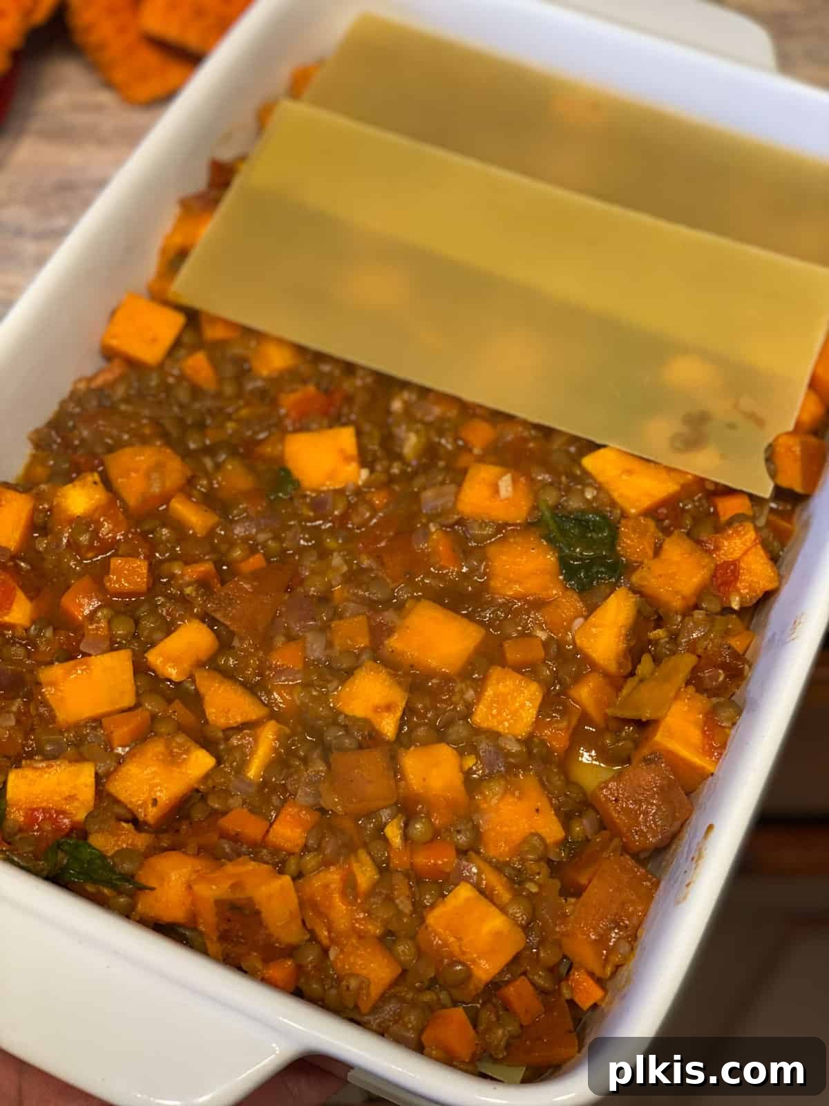 Deliciously Easy Vegan Sweet Potato Lasagna 15 process shot of adding lasagna sheets to baking dish