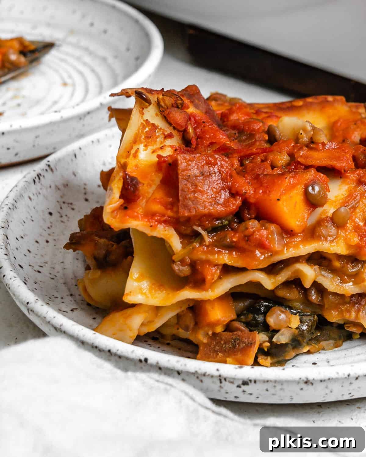 Deliciously Easy Vegan Sweet Potato Lasagna 19 completed Easy Sweet Potato Lasagna plated on a white plate