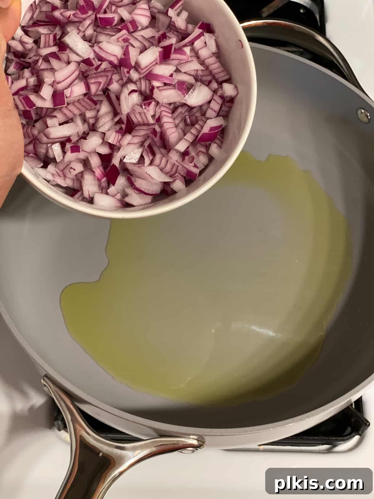 Deliciously Easy Vegan Sweet Potato Lasagna 4 process shot of adding onions to pan