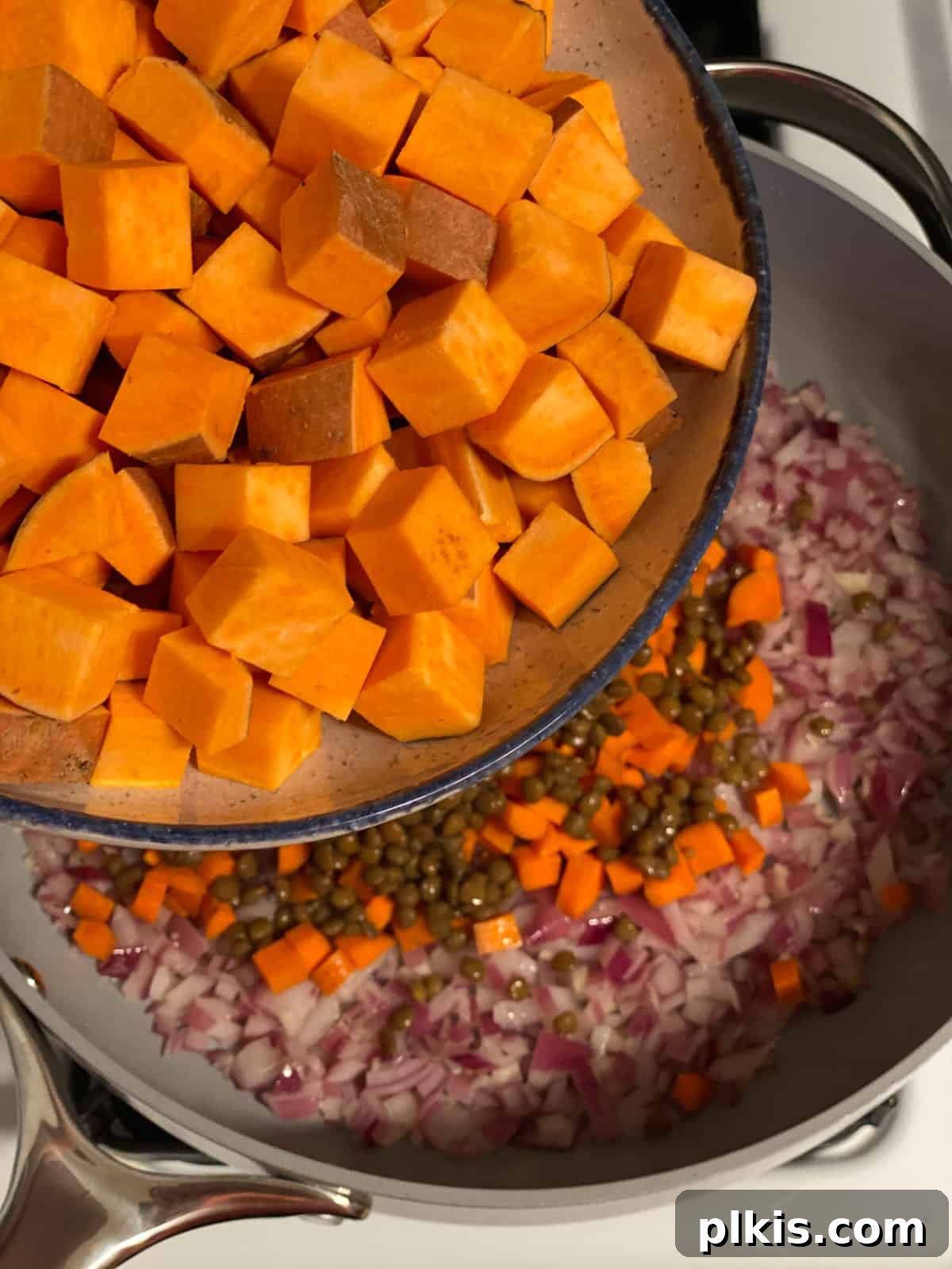 Deliciously Easy Vegan Sweet Potato Lasagna 8 process shot of adding sweet potatoes to pan