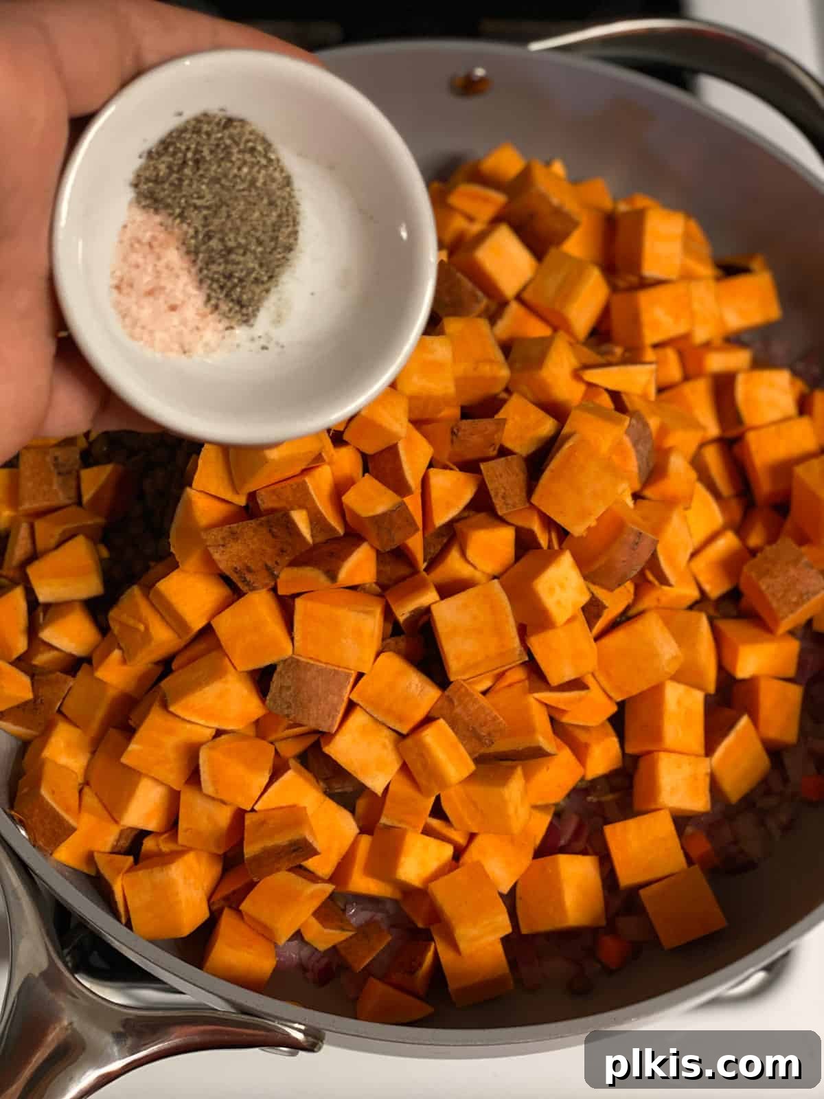 Deliciously Easy Vegan Sweet Potato Lasagna 9 process shot of adding seasonings to pan