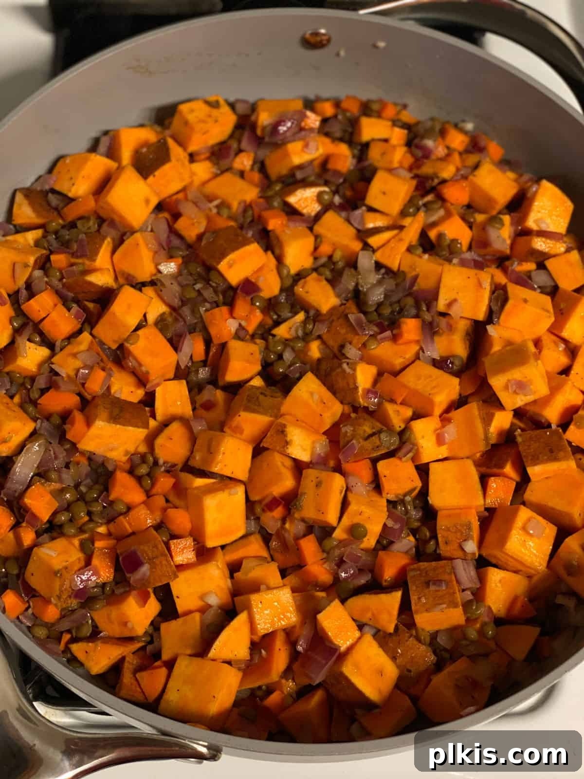 Deliciously Easy Vegan Sweet Potato Lasagna 10 process shot of mixing ingredients together in pan