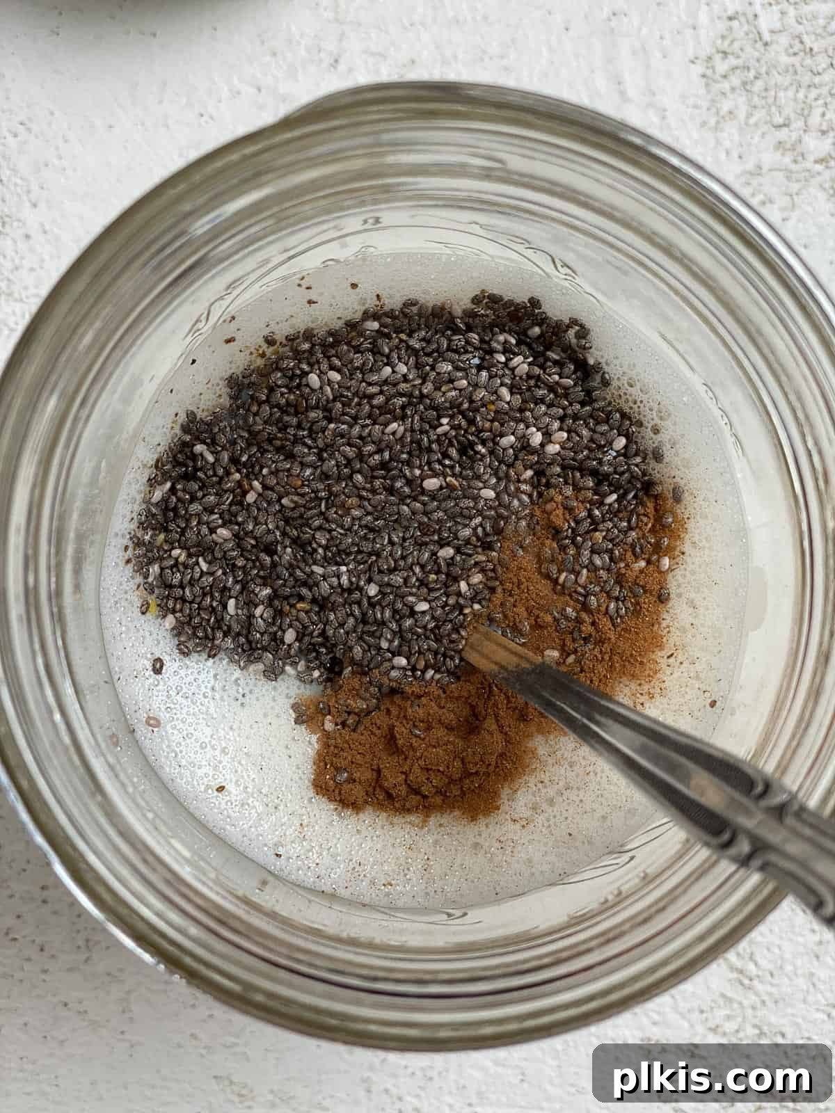 Decadent Salted Caramel Overnight Oats 5 process shot of mixing Salted Caramel Overnight Oats ingredients in a glass jar