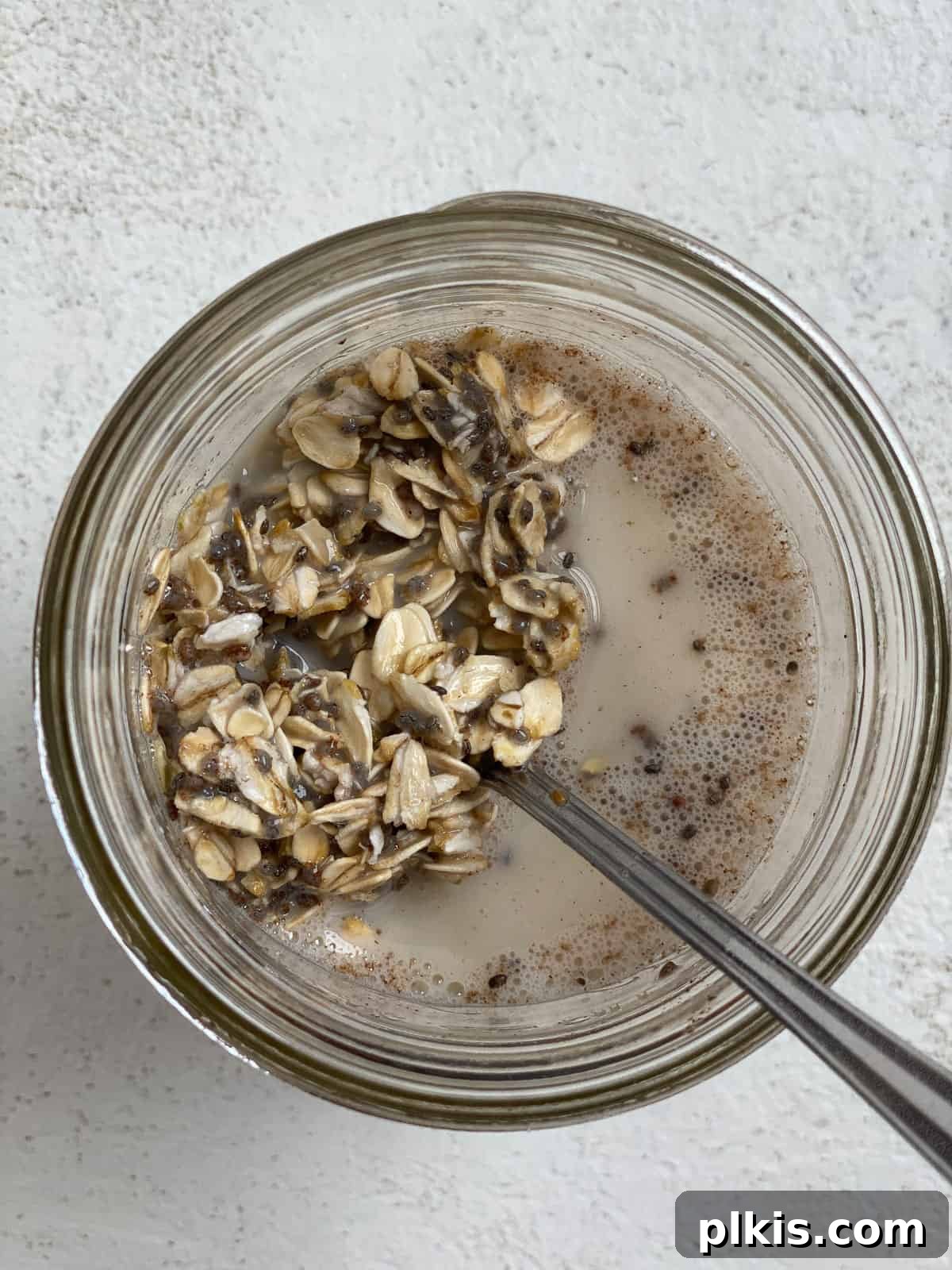 Decadent Salted Caramel Overnight Oats 7 process shot of mixing in oatmeal in glass jar