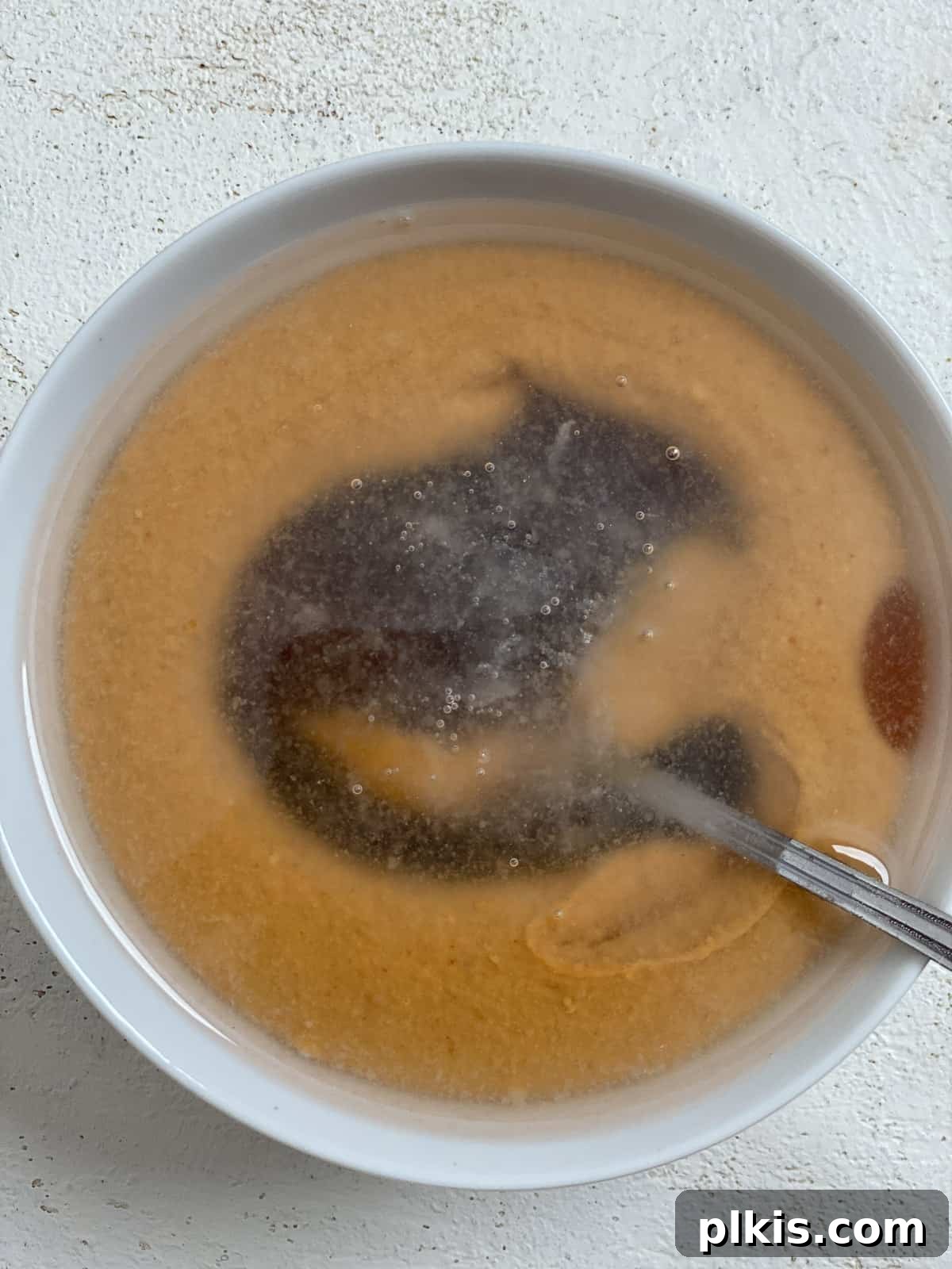 Decadent Salted Caramel Overnight Oats 9 process shot of mixing caramel ingredients for Salted Caramel Overnight Oats in a bowl