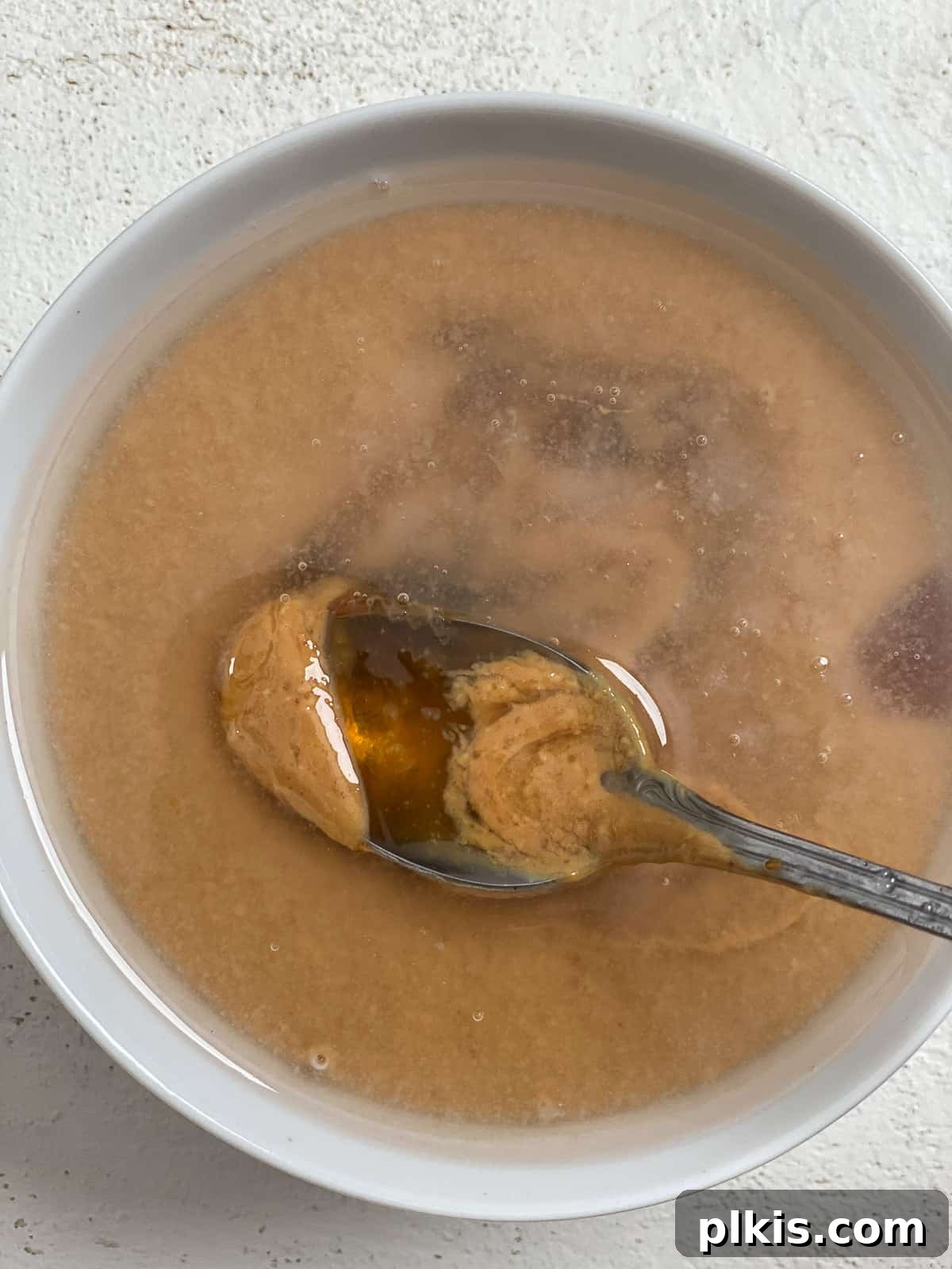 Decadent Salted Caramel Overnight Oats 10 process shot of mixing caramel ingredients for Salted Caramel Overnight Oats in a bowl