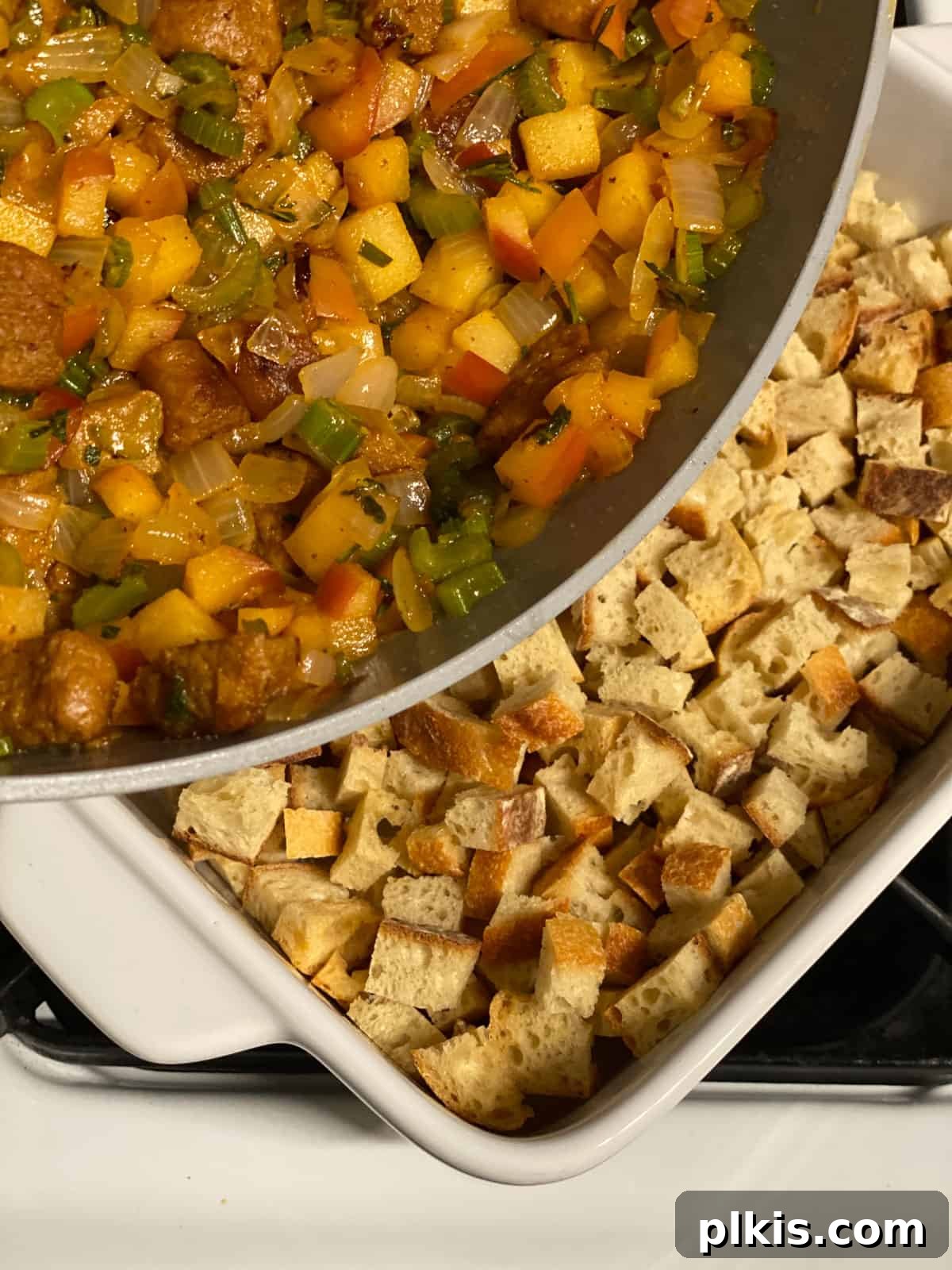 Ultimate Vegan Stuffing 6 Cooked vegetables and vegan sausage being mixed with dried sourdough bread cubes in a large casserole dish.