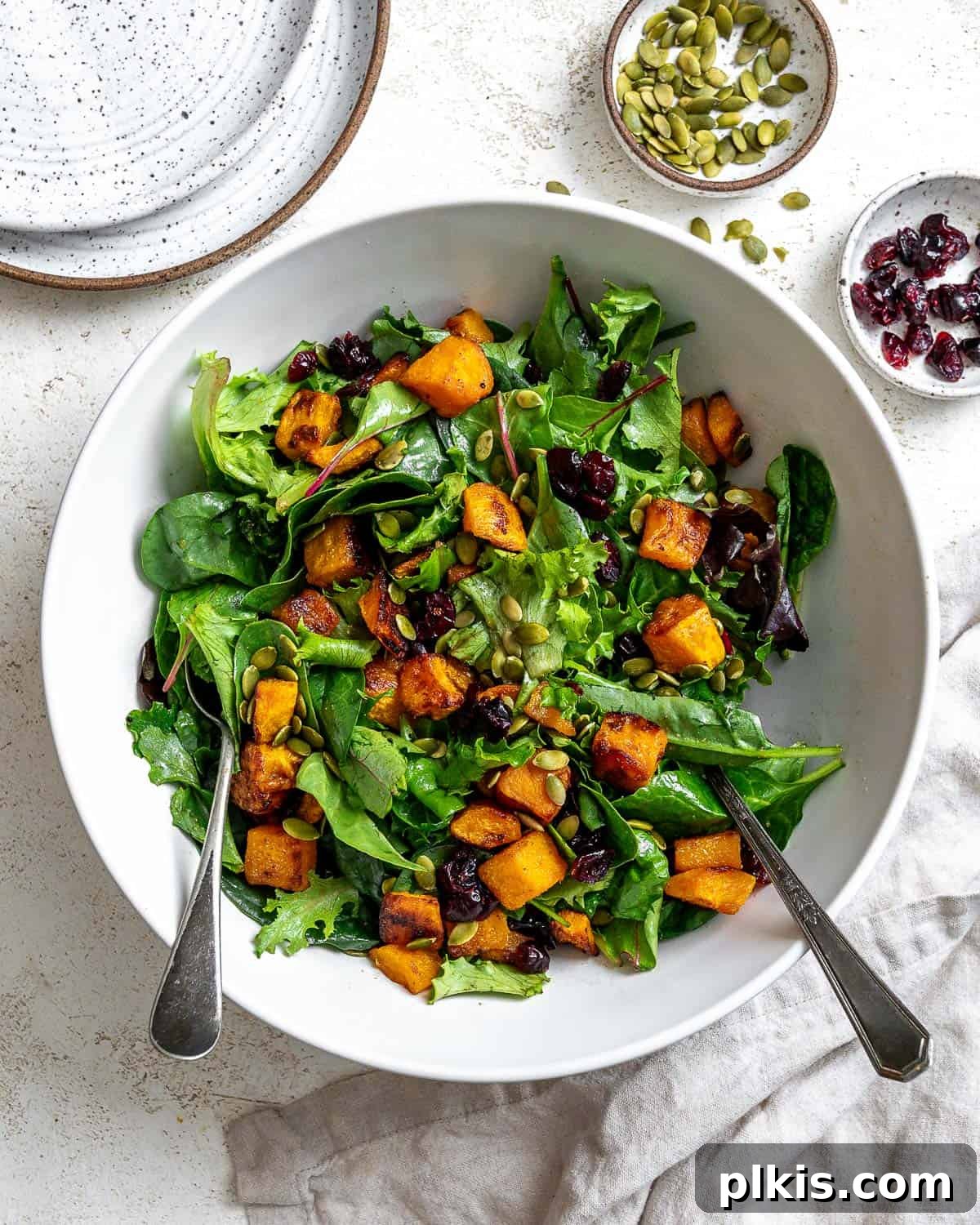 Roasted Pumpkin Harvest Salad 2 completed Easy Roasted Pumpkin Salad plated on a white surface