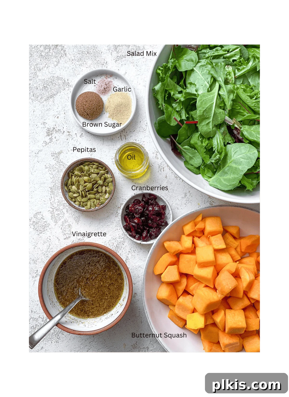 Roasted Pumpkin Harvest Salad 3 ingredients for Easy Roasted Pumpkin Salad measured on a white surface