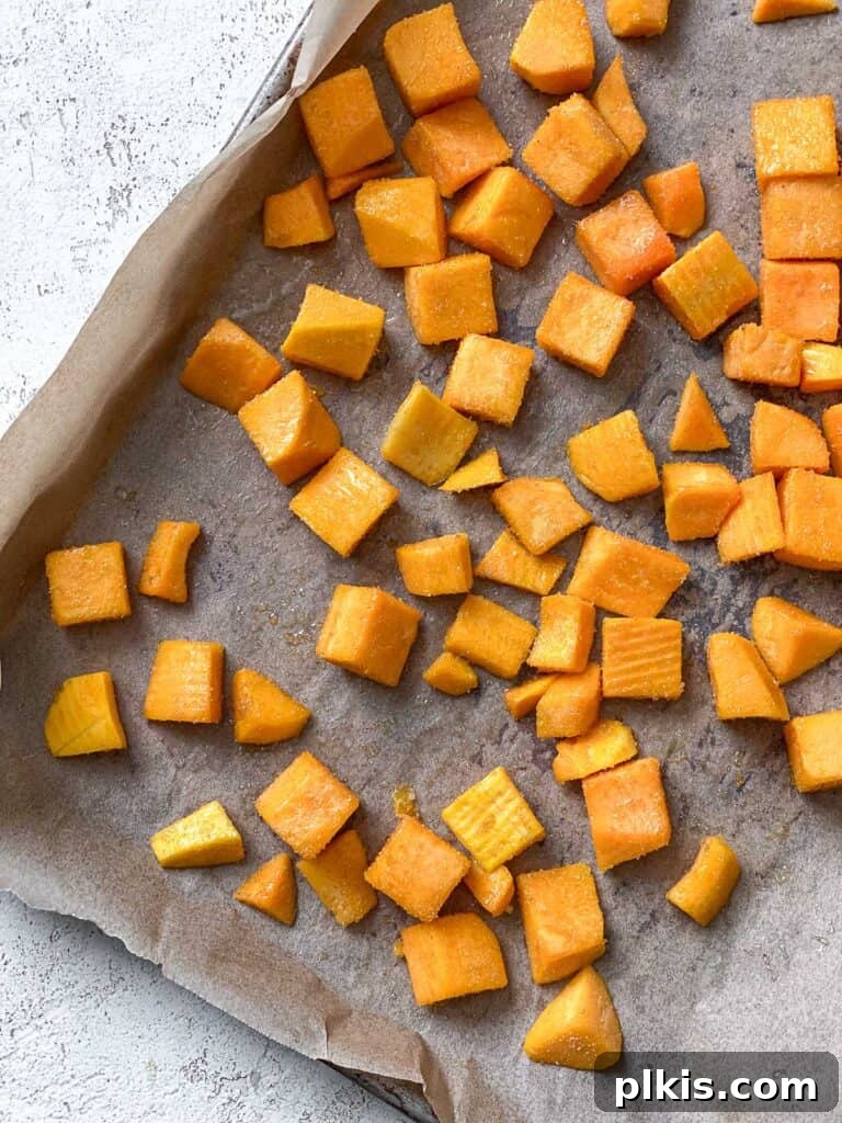 Roasted Pumpkin Harvest Salad 5 process shot of pumpkin in bking dish with added seasonings