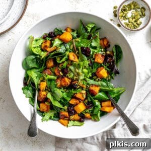 completed Easy Roasted Pumpkin Salad plated on a white surface