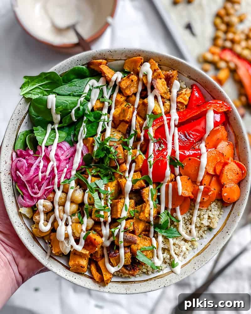 Roasted Sweet Potato Quinoa Power Bowl 2 A beautifully assembled Sweet Potato Quinoa Bowl, brimming with colorful roasted vegetables, fluffy quinoa, and a creamy tahini dressing.