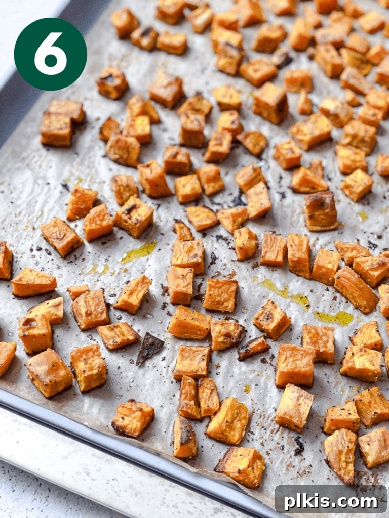 Roasted Sweet Potato Quinoa Power Bowl 9 Process shot of perfectly roasted and caramelized sweet potato cubes on a baking sheet, fresh from the oven.