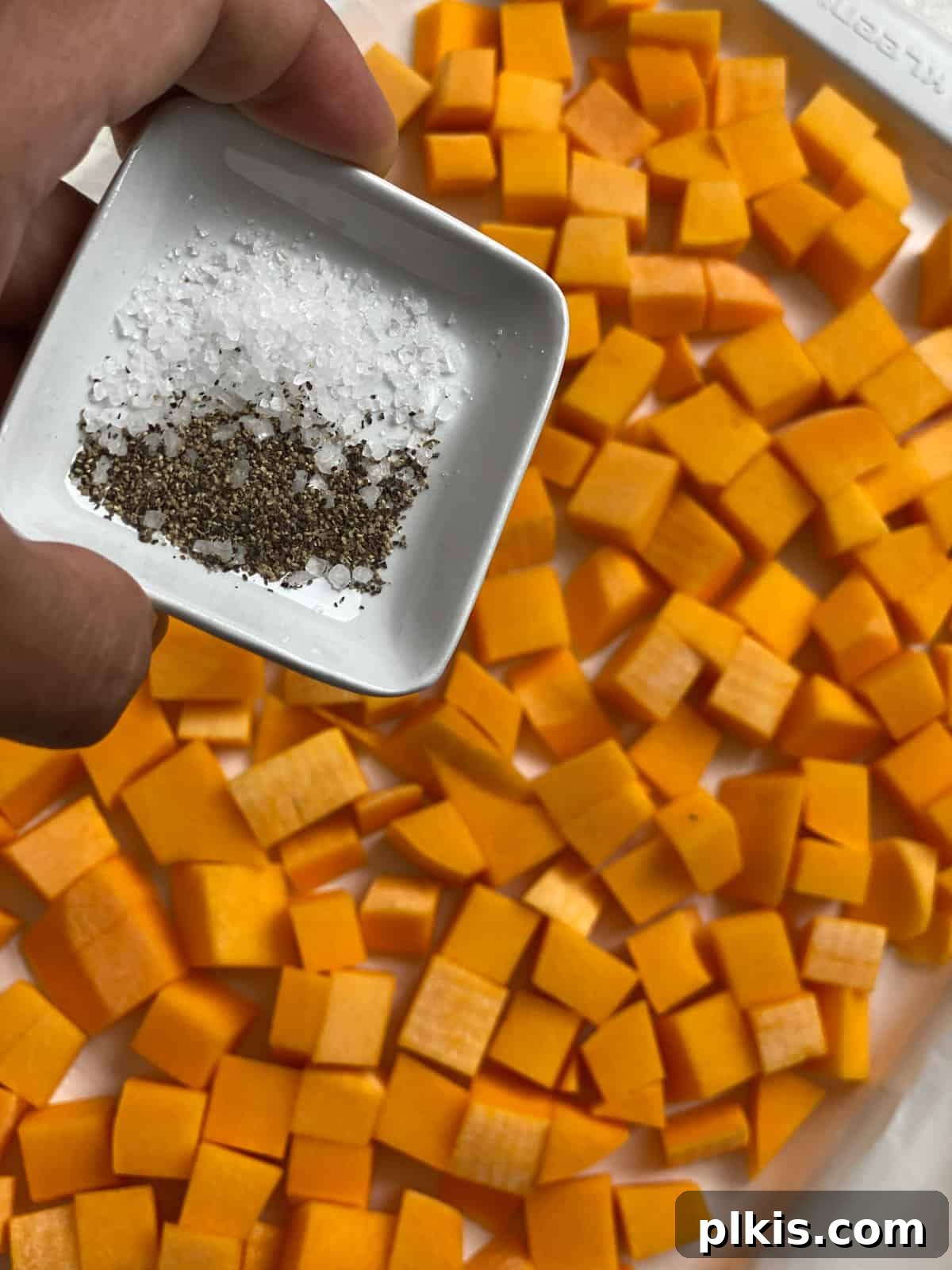 Creamy Vegan Pumpkin Dream 4 process of adding seasonings to pumpkin in baking tray