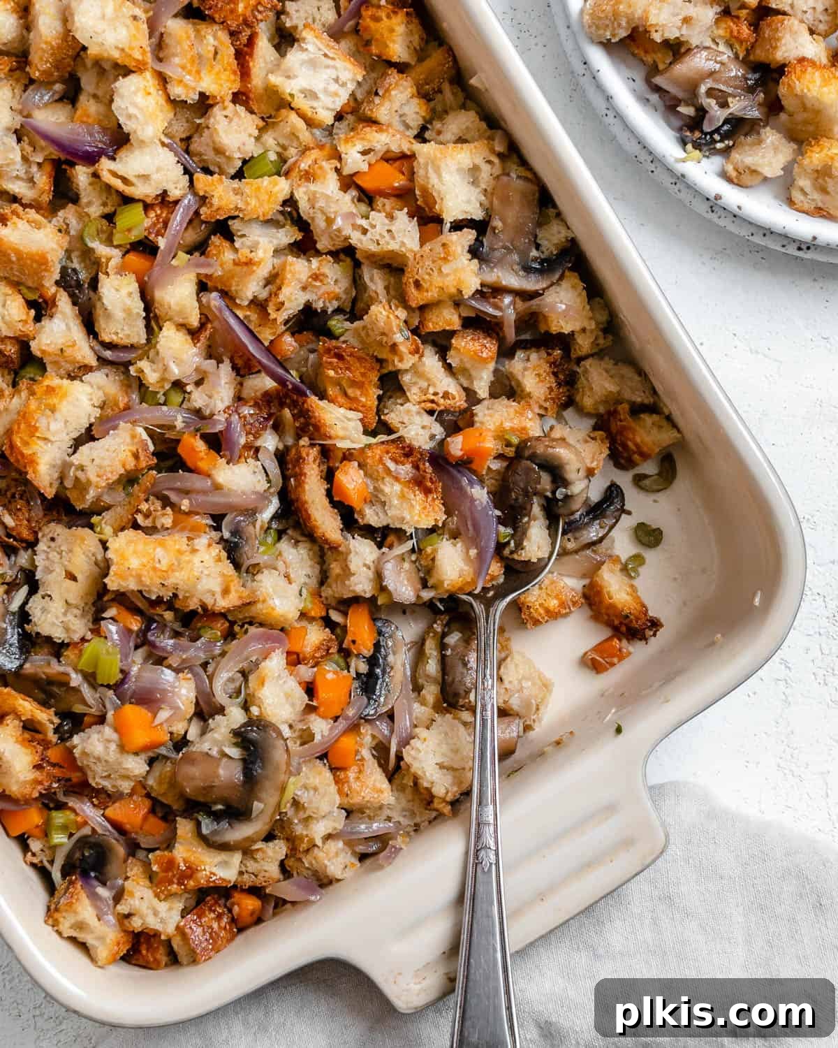 Simple & Savory Mushroom Stuffing 14 completed Easy Mushroom Stuffing Recipe in dish alongside a plated serving