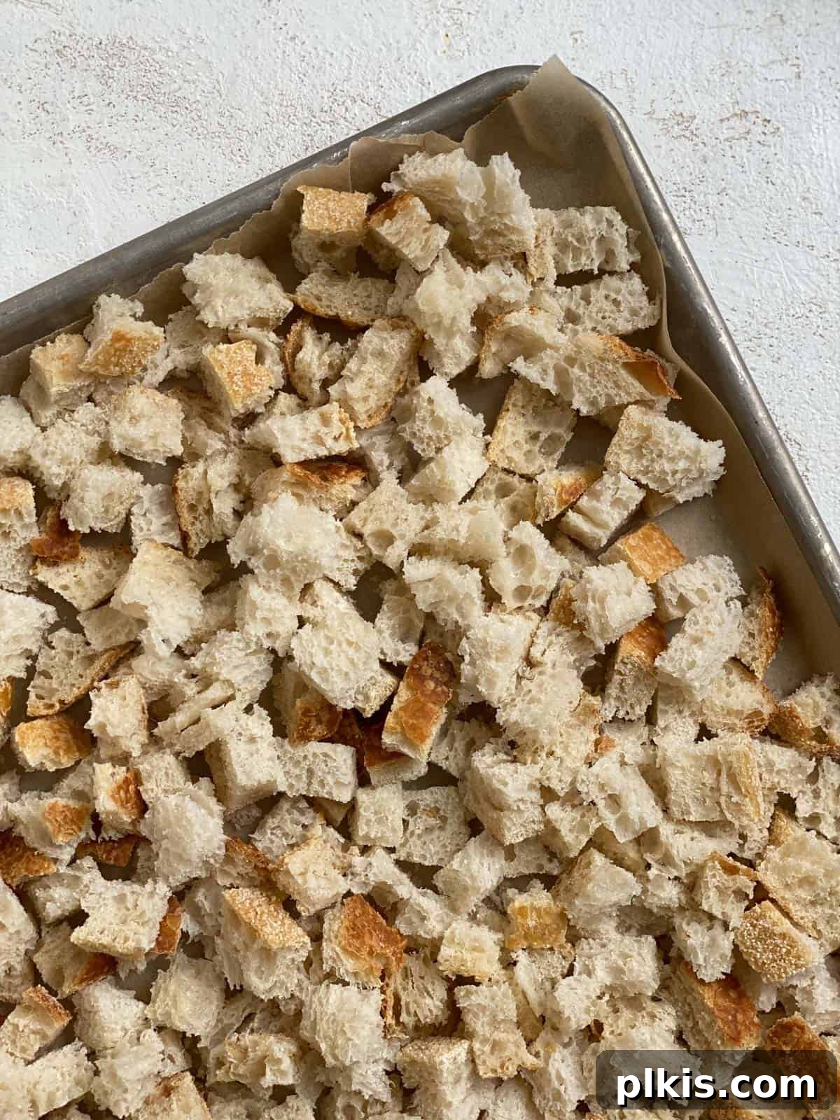 Simple & Savory Mushroom Stuffing 4 process of adding bread to tray