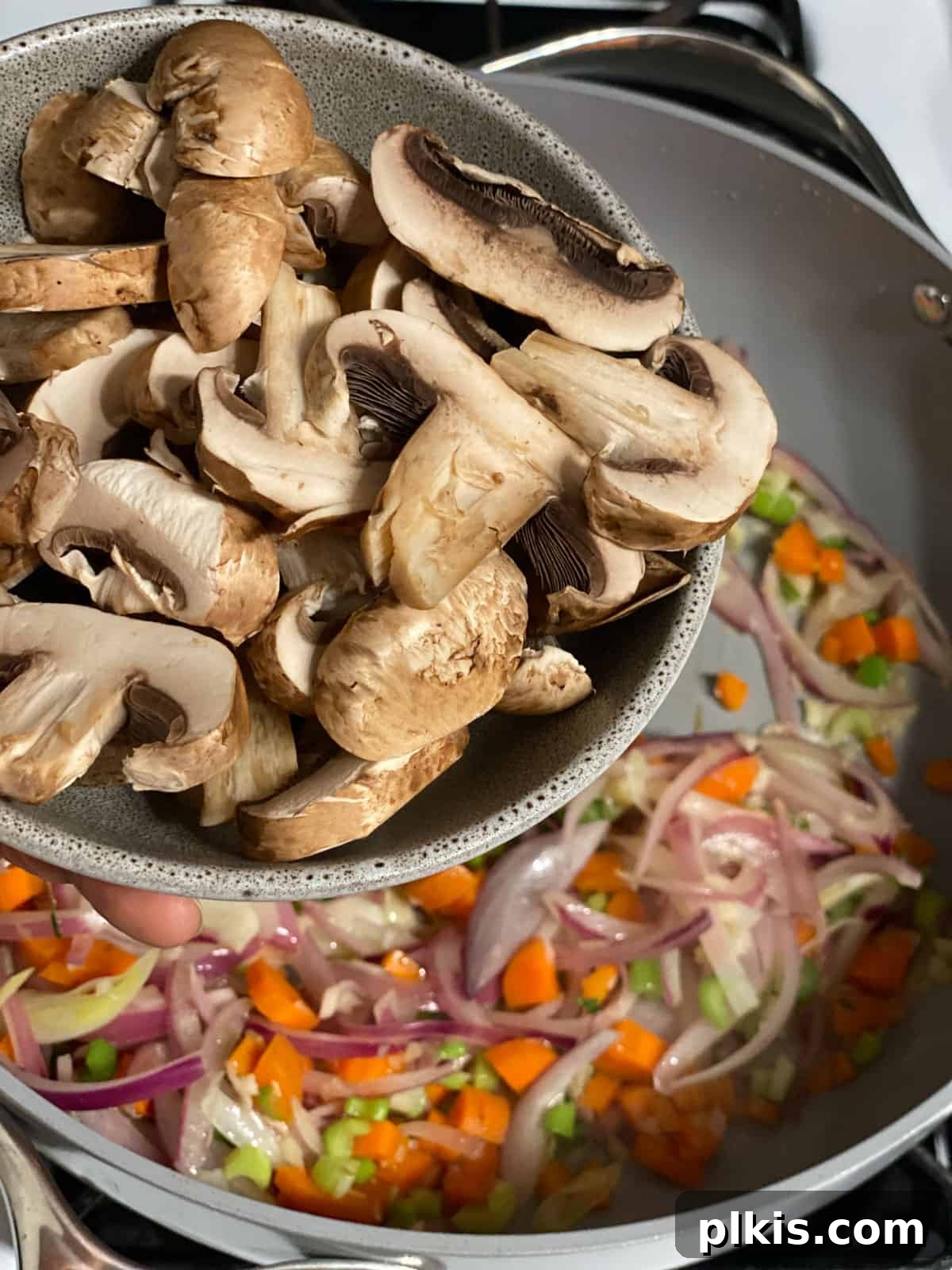 Simple & Savory Mushroom Stuffing 7 process of adding mushrooms to pan