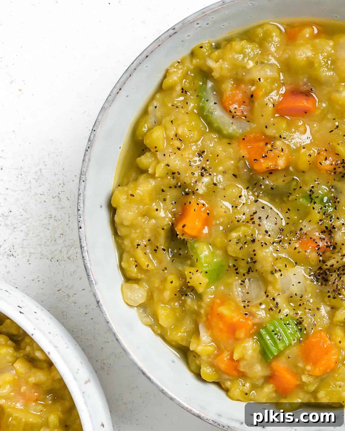 Golden Vegan Split Pea Goodness 7 A visually appealing final shot of Vegan Split Pea Soup in a white bowl, ready to be enjoyed, highlighting its comforting nature.
