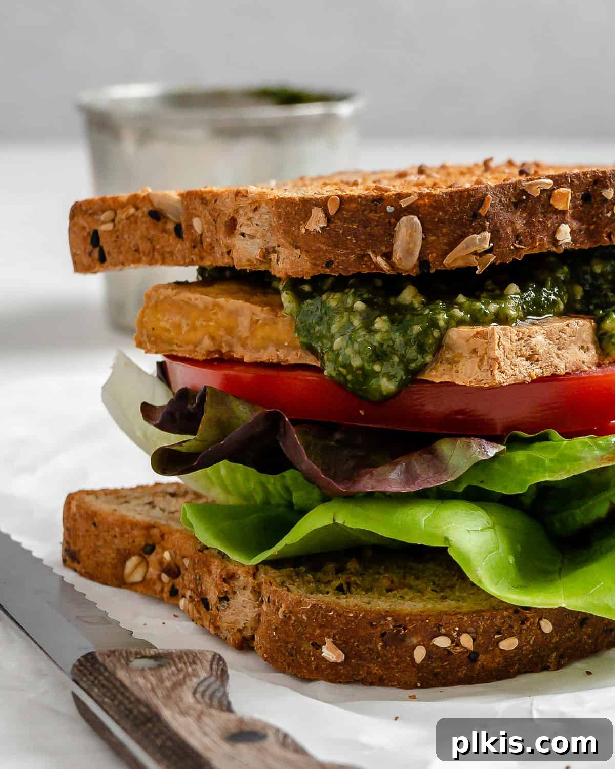 Pesto Tofu Sandwich: Simple Savory Superb 9 A completed vegan pesto tofu sandwich, beautifully presented on a white surface, showcasing the vibrant layers and inviting textures. Ready to be enjoyed as a healthy and satisfying meal.
