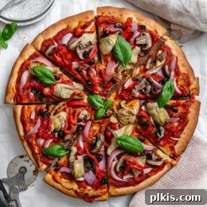 Simple Plant-Based Pizza Crust 11 completed Easy Vegan Pizza Dough with pizza toppings on top on white surface