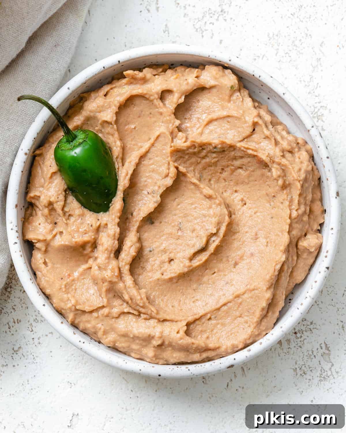 Creamy Pinto Delight 2 A beautifully presented bowl of creamy Mexican Pinto Bean Dip, ready to be enjoyed.