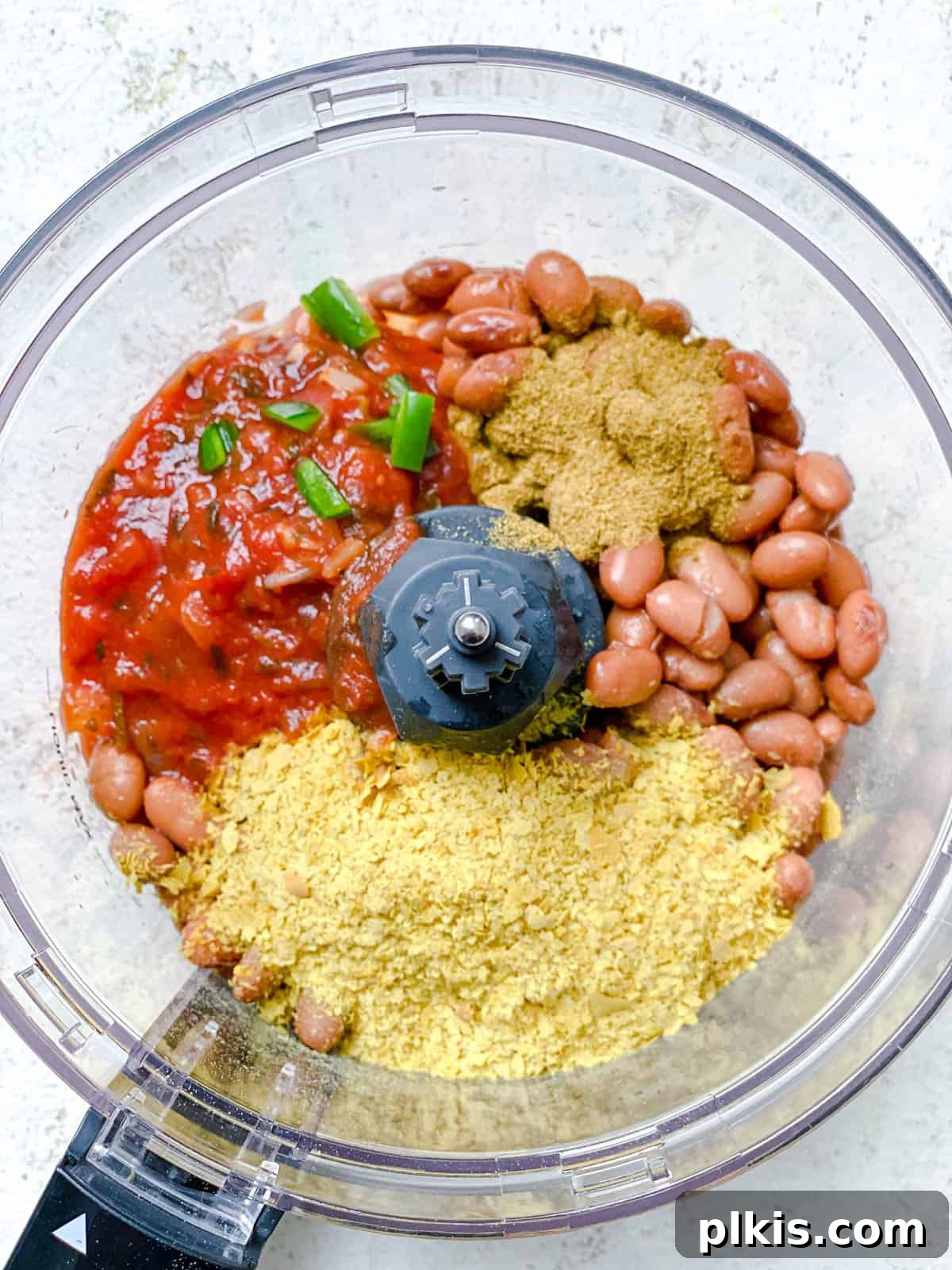 Creamy Pinto Delight 4 Process shot showing all the main ingredients for Mexican Pinto Bean Dip placed inside a food processor, ready for blending.