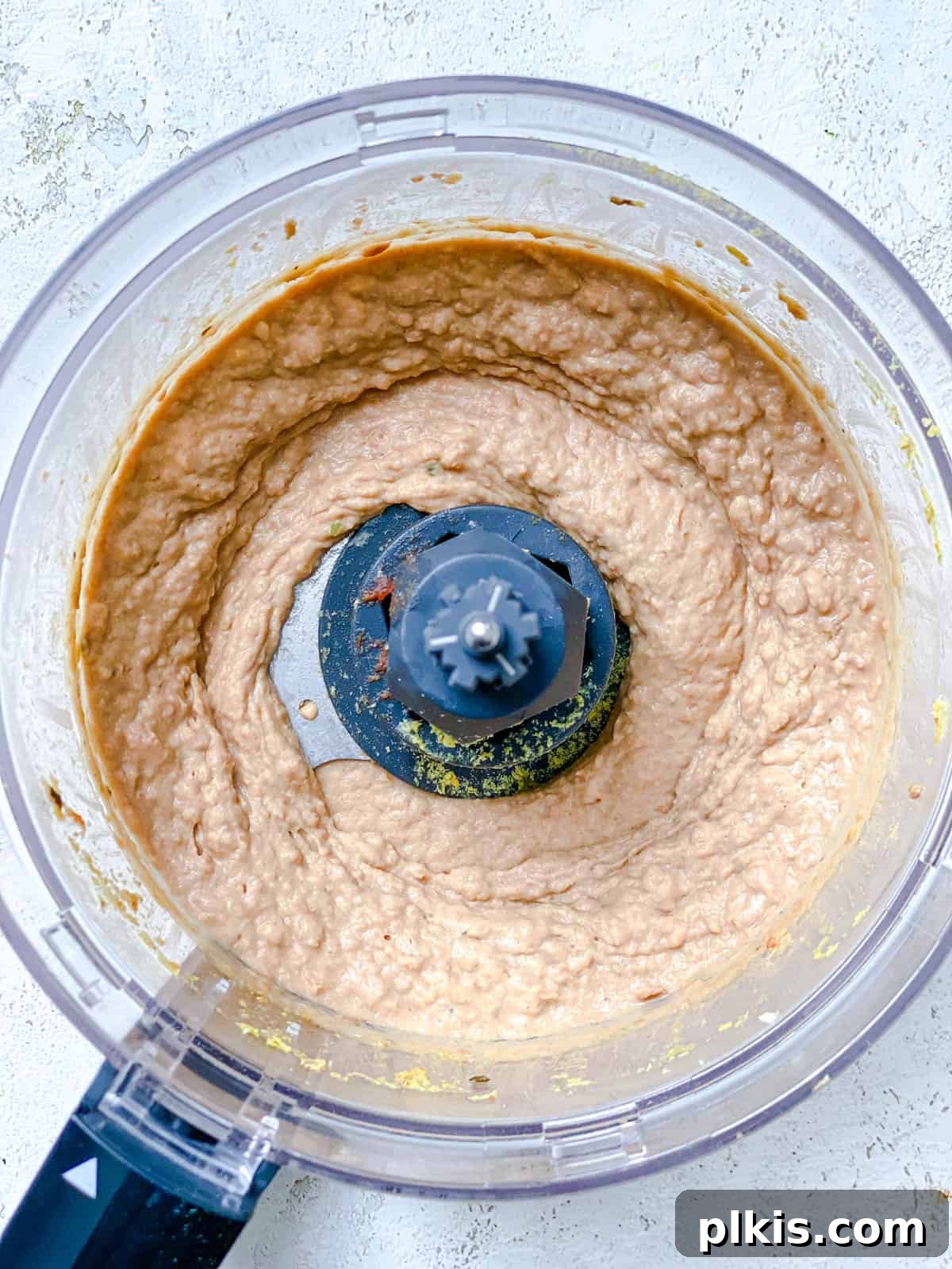 Creamy Pinto Delight 5 Process shot illustrating the ingredients fully processed and blended into a smooth, creamy dip consistency within the food processor.