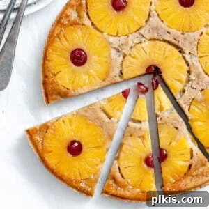 completed Vegan Pineapple Upside Down Cake sliced against a light surface