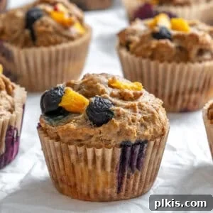 completed Blueberry Peach Muffins on white surface