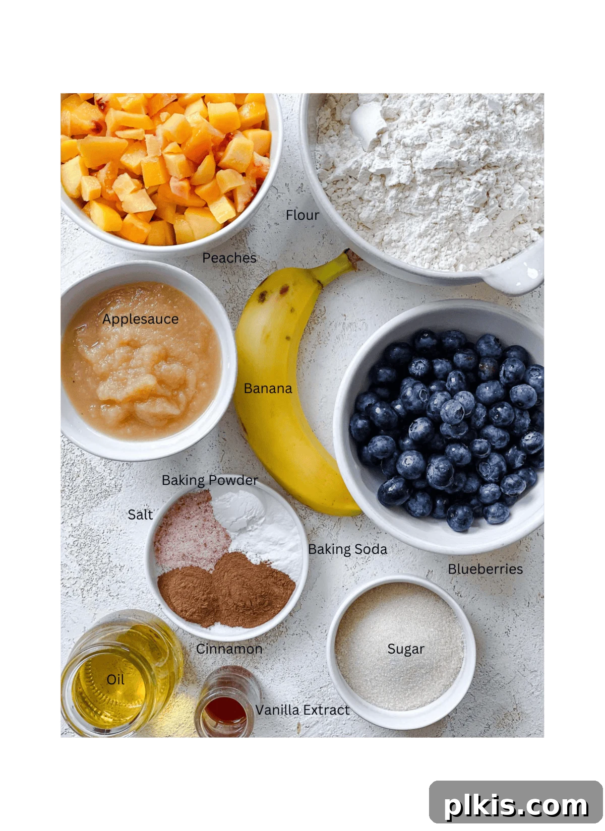 Bursting Blueberry Peach Delights 3 ingredients for Blueberry Peach Muffins measured out on a white surface