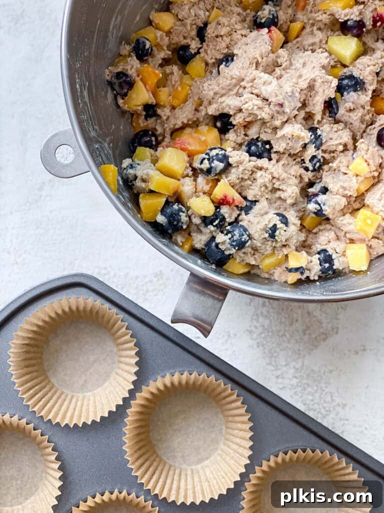 Bursting Blueberry Peach Delights 6 batter alongside muffin tin