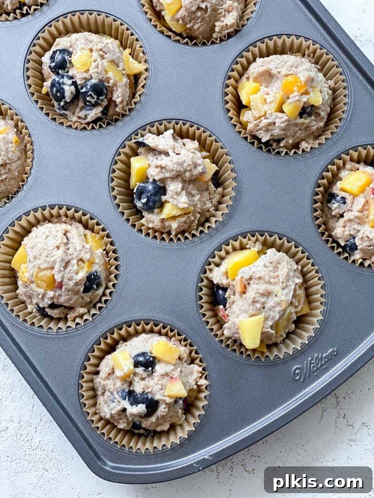 Bursting Blueberry Peach Delights 7 process shot showing batter added to muffin tin