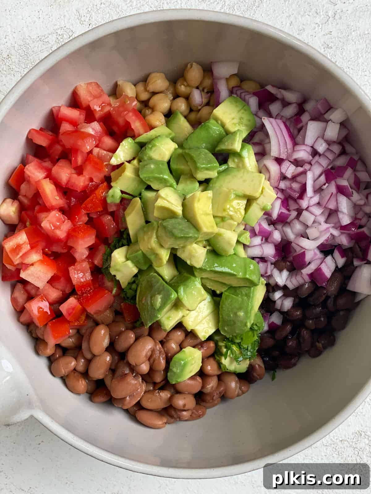 Southwestern Confetti Salad with Avocado 4 process shot of mixing ingredients together in a bowl