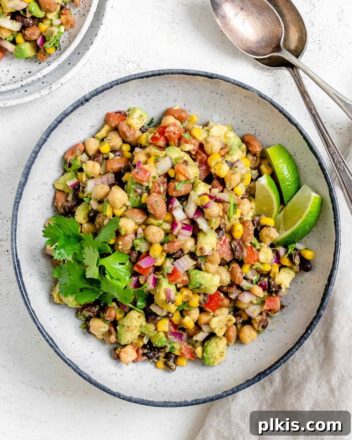 completed Texas Caviar [Avocado Corn and Bean Salad] in a white plate against a light background
