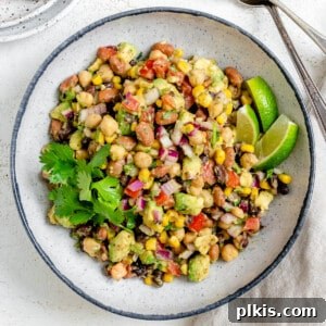 completed Texas Caviar [Avocado Corn and Bean Salad] in a white plate against a light background
