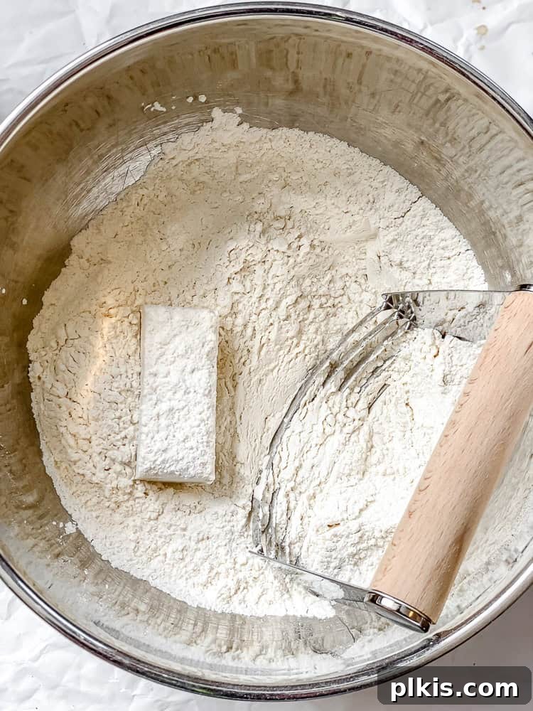 Southern Comfort Reimagined Vegan 6 Process shot showing cutting frozen vegan butter into flour with a pastry cutter.