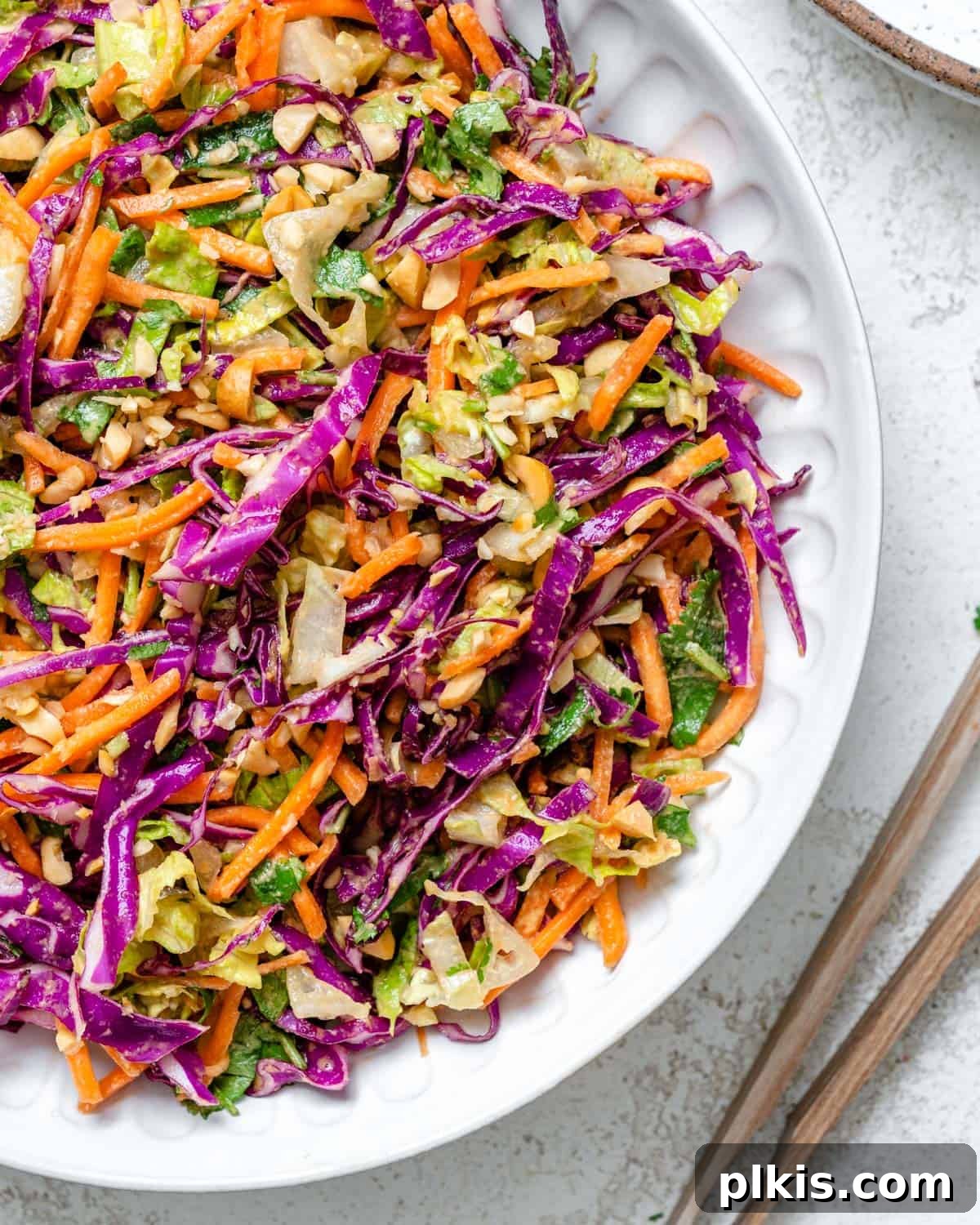 Zesty Thai Peanut Salad 2 A beautifully presented Crunchy Thai Peanut Salad in a white bowl, set against a clean white background, highlighting its fresh ingredients and vibrant colors. Perfect for a healthy meal.