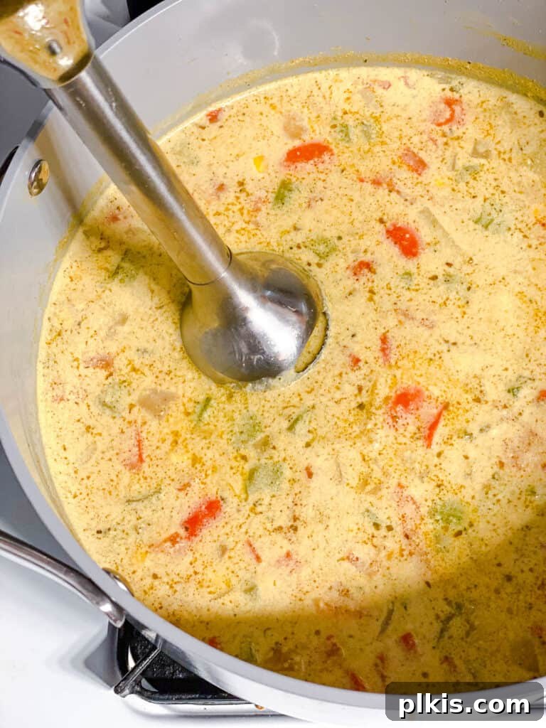 Golden Harvest Chowder 12 process shot of using immersion blender in pot