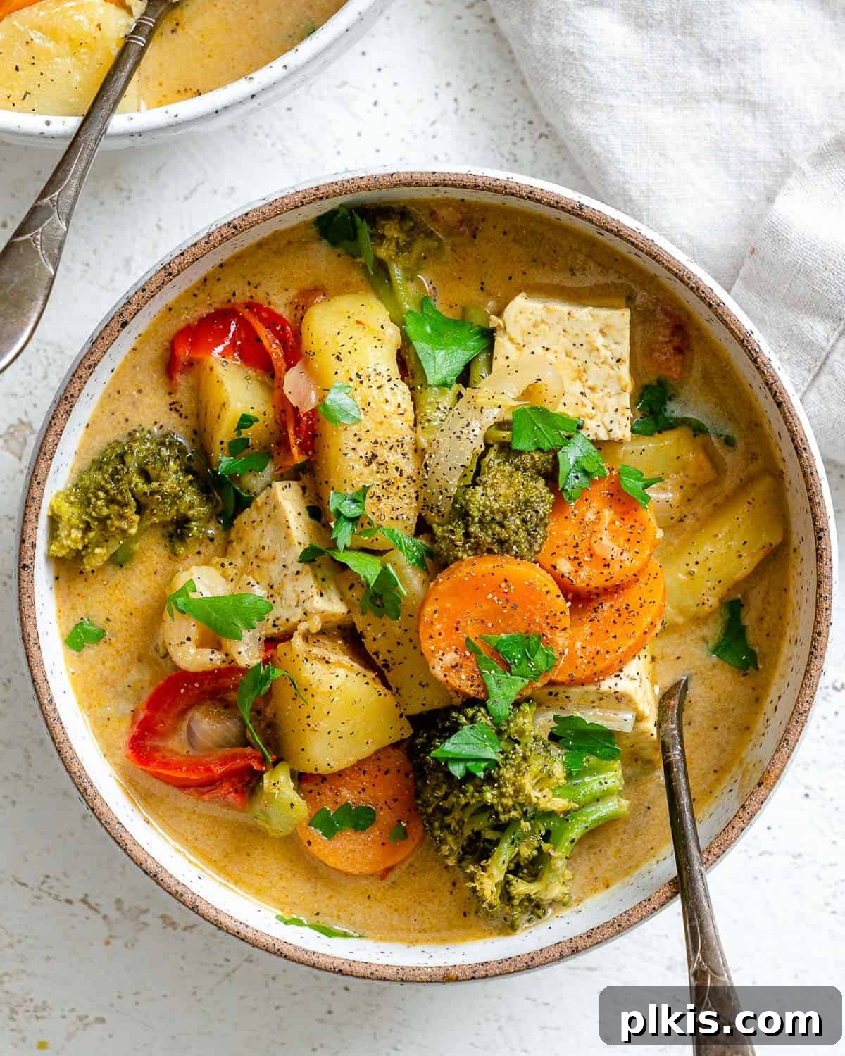 Creamy One-Pot Vegan Yellow Tofu Curry 9 Another mouth-watering shot of the Tofu Yellow Curry in a bowl, showcasing its vibrant ingredients and rich, golden sauce, ready to be served.