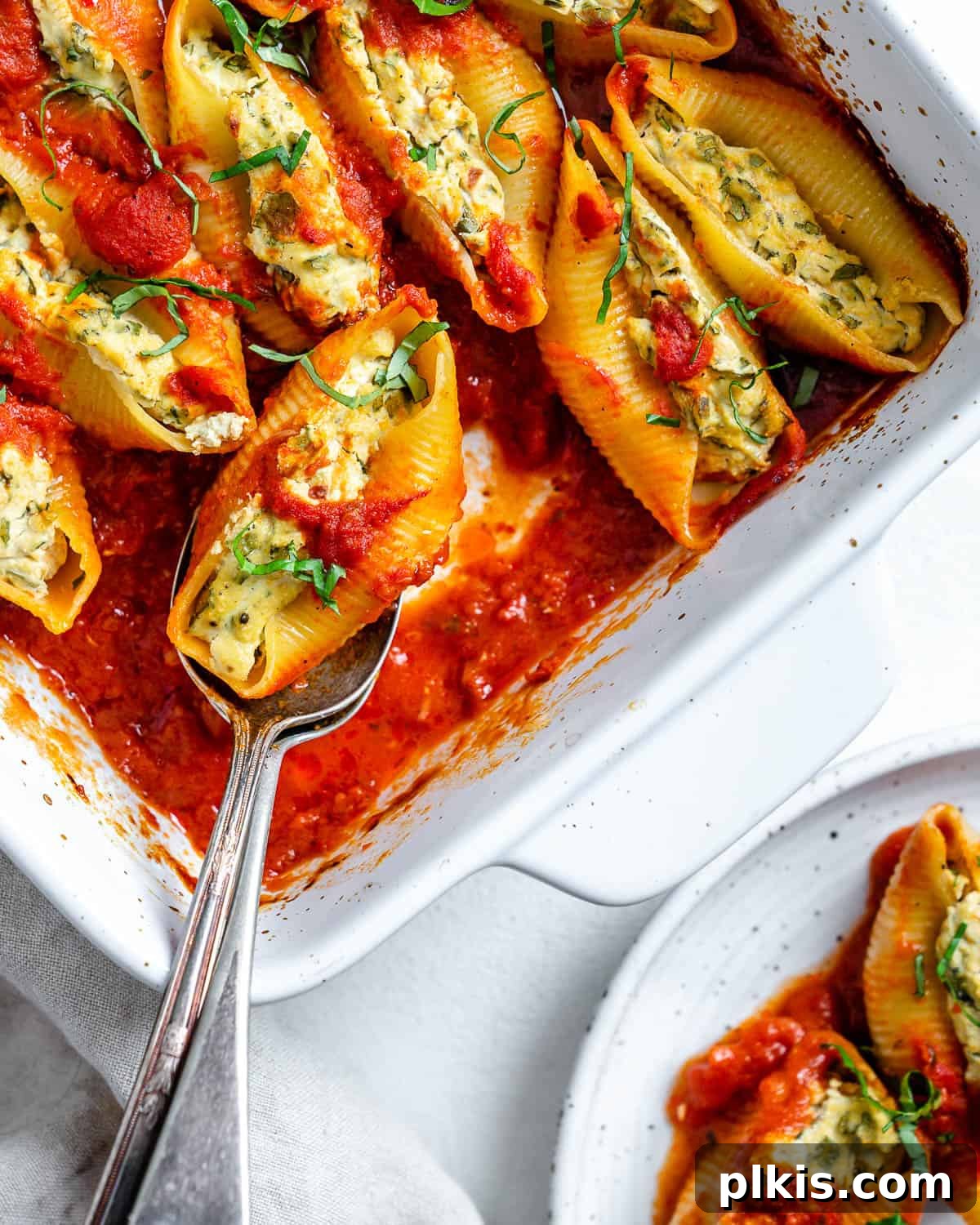 Creamy Vegan Stuffed Shells 20 Another beautiful shot of the completed Vegan Stuffed Shells in a white baking dish, presented against a clean white background, emphasizing their appetizing appeal.